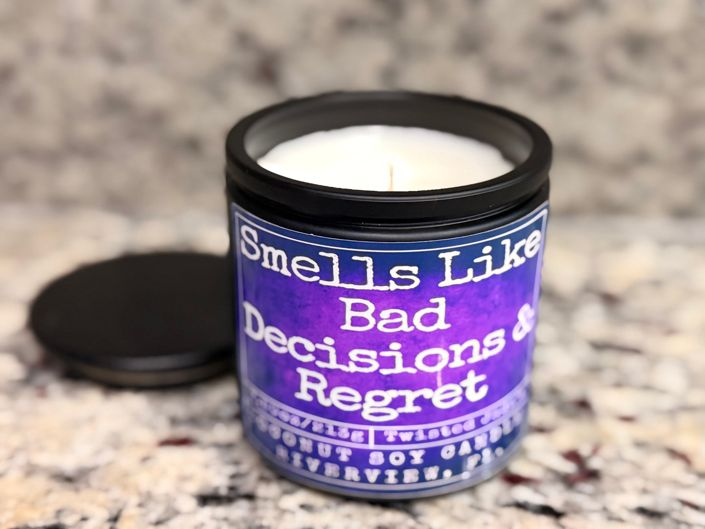 Candle with a humorous label on a textured surface
