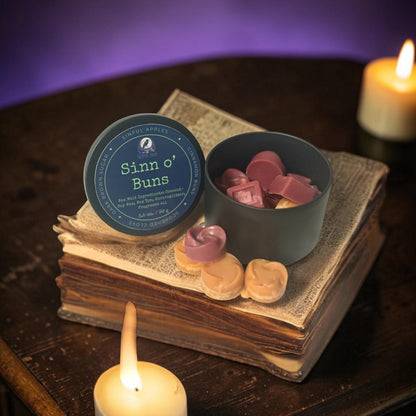 Twisted Jade's Sinn O' Buns wax melts in a tin and dish, featuring apple, cinnamon, clove, and brown sugar scents.